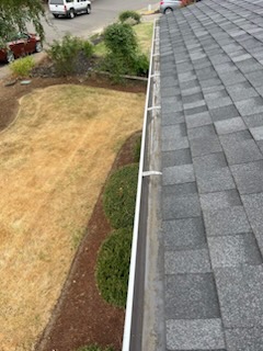 A clean white gutter and roofline after cleaning